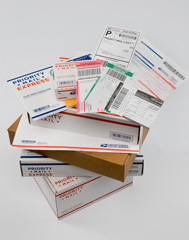 various of USPS packages, labels, and forms stacked on top of one another